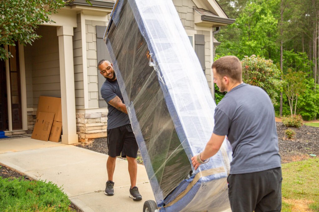 South Metro Atlanta Movers, Larry and Joe, moving a sofa out of a fayetteville home.